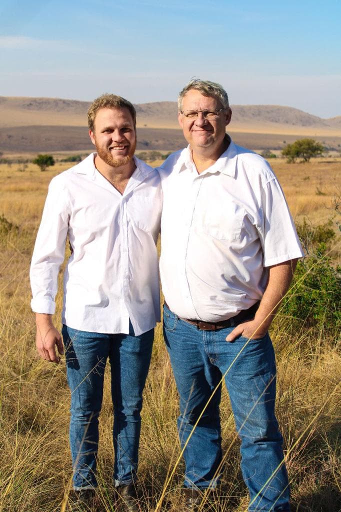 In a field, Vincent and Hendrik Stockigt pose together, showcasing their collaboration as father and son at STC Motion.